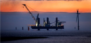 The first of the fully-fitted wind turbines stands in silhouette off Redcar.jpg